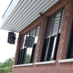 Noho waterproof speakers on the press box façade following masonry work to smooth the textured brick surface for the mounts
