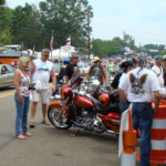 Motorcycle enthusiasts gather in downtown Sturgis. KNKL announcers offer public safety over the Technomad loudspeakers as inclement weather and other situations arise. Photo credit to Jimmy Smith.