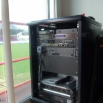 The complete system includes amplifiers and mixers, a wireless microphone, and an automated playout system for security announcements