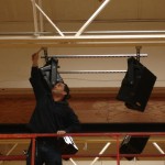 Alex DeMartino at Syracuse Time & Alarm hangs Nohos in the South Lewis middle school gym